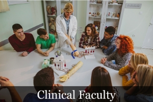 Clinical faculty teaching students how to draw blood from a test arm